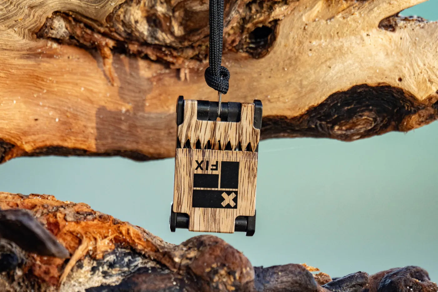 FIX multi-tool hanging from a driftwood branch