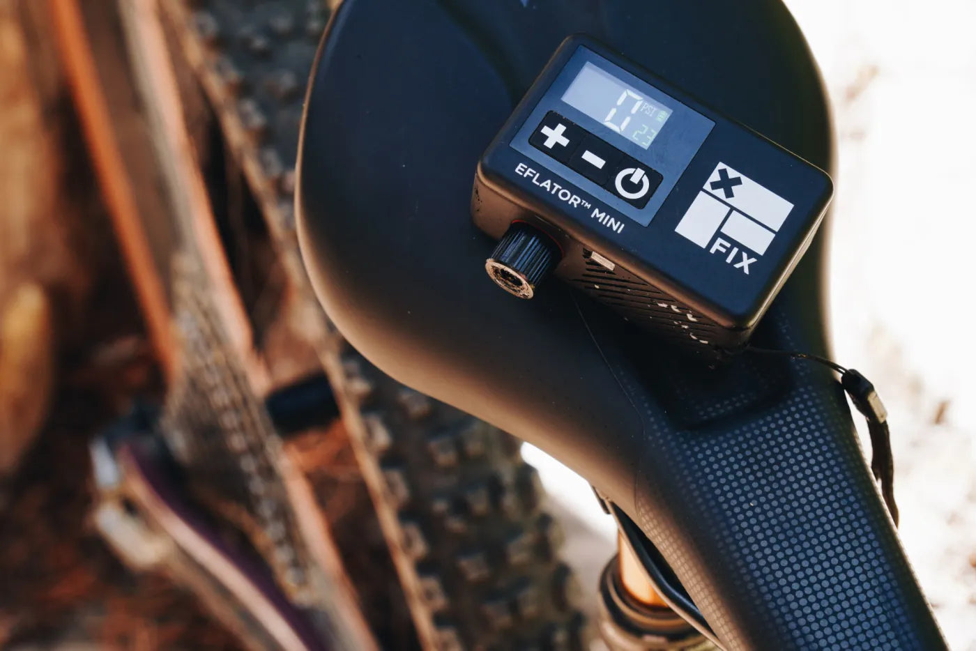 Eflator Mini digital pump on a mountain bike saddle
