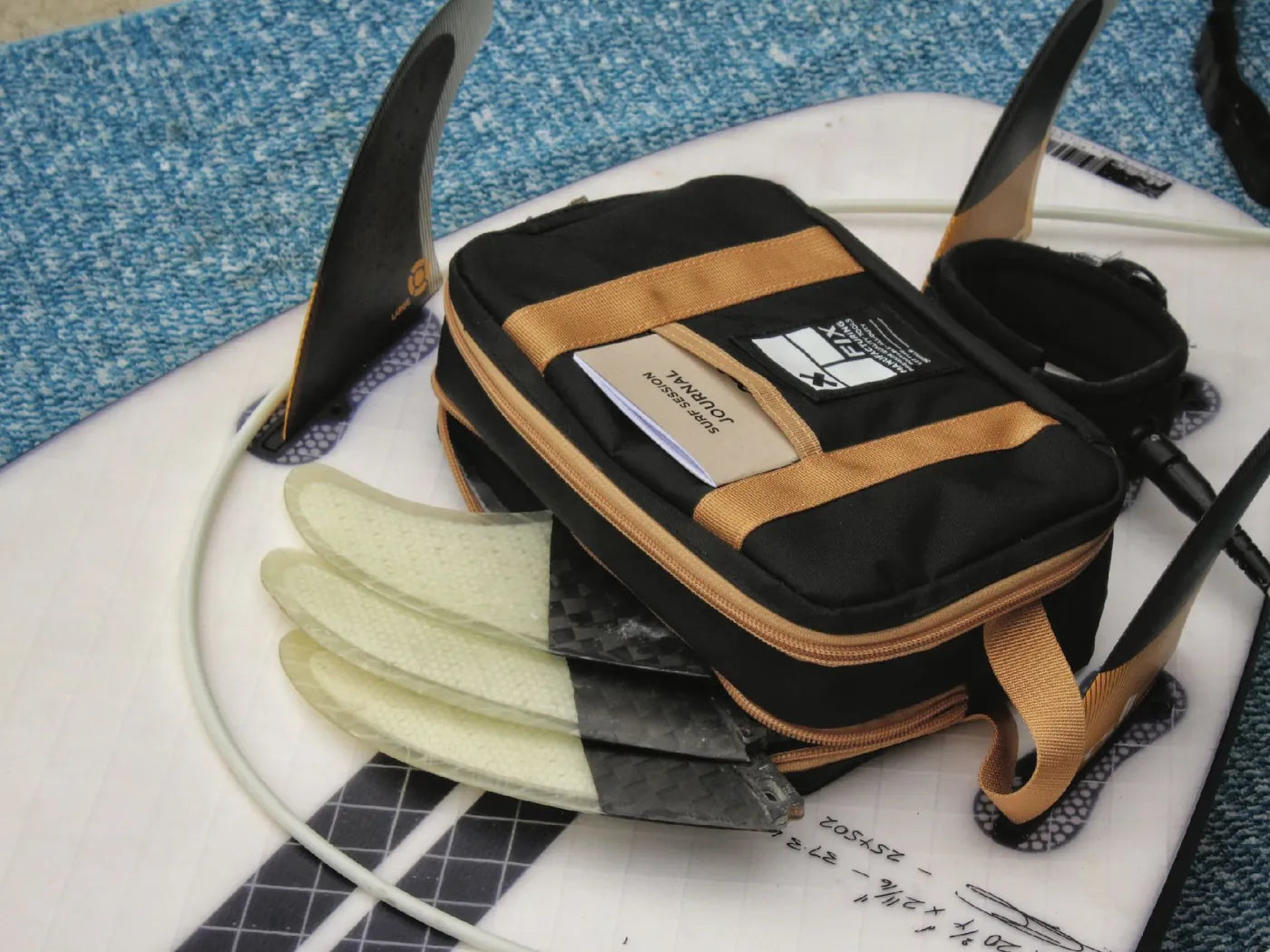 FIX pouch with surf fins on a surfboard